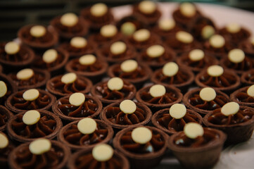 A platter of mini chocolate custard cups served at a wedding banquet.