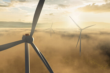 wind energy above misty community at sunrise. concept for green technology.