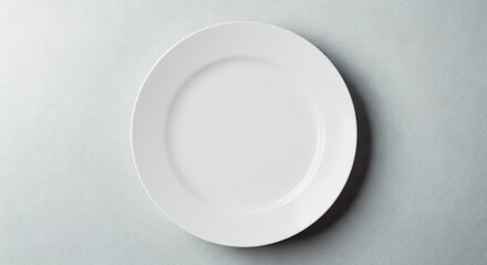 Empty white ceramic plate top view (flat lay) on a gray background