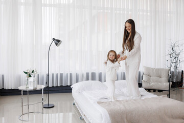 Mother and daughter enjoy playtime together in a modern living room during daylight hours