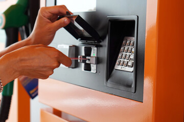 Woman's Hands Inserting Credit Card to Make a Gas Payment at a Gas Station
