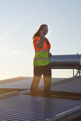 Renewable Energies. Female Solar Panel Installer Technician Checking an Installation While Talking...