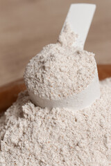 Plastic measuring scoop with protein powder