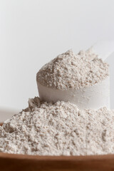 Plastic measuring scoop with protein powder