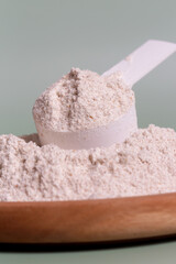 Plastic measuring scoop with protein powder