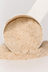 Plastic measuring scoop with protein powder