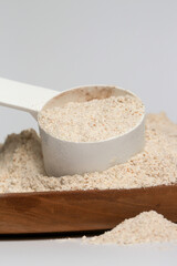 Plastic measuring scoop with protein powder