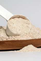 Plastic measuring scoop with protein powder