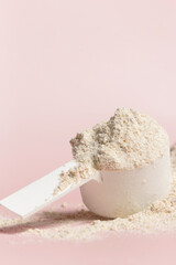 Plastic measuring scoop with protein powder