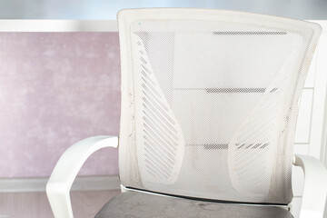 Dirty gray computer chair with stains on upholstery fabric, dry cleaning, close-up