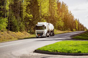 Tank truck transports chemical product, liquefied gas, dangerous cargo. Beautiful summer sunny...