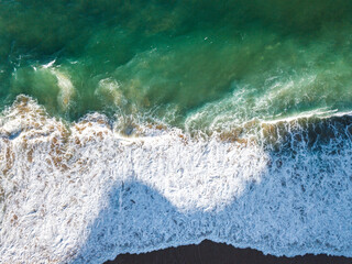 Aerial View of Ocean Waves Hitting Sandy Shore. Aerial drone view. natural background