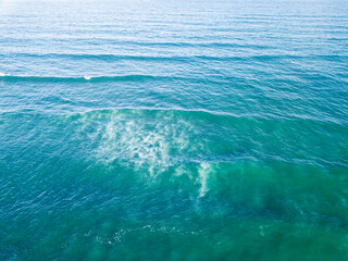 Aerial View of Ocean Waves Hitting Sandy Shore. Aerial drone view. natural background