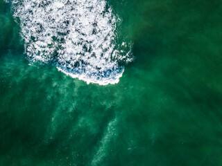 Aerial View of Ocean Waves Hitting Sandy Shore. Aerial drone view. natural background