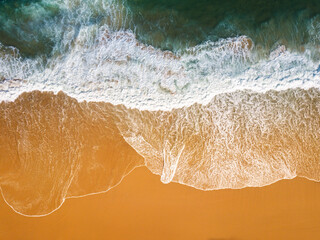 Aerial View of Ocean Waves Hitting Sandy Shore. Aerial drone view. natural background