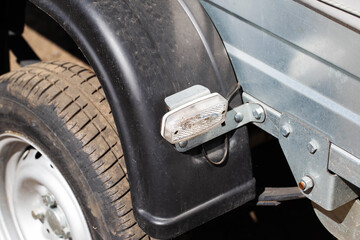 New wheel with tire and mudguard on trailer, close-up