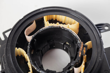 disassembled broken steering column electrical cable on white background, isolate, close-up