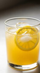 Refreshing citrus drink with ice and lemon slice.