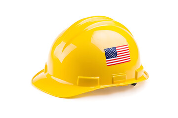 Fototapeta premium Yellow protective construction hard hat against a white background, with an American flag sticker on the side symbolizing labor.