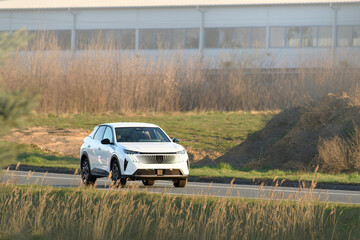 Modern electric car cruising country highway