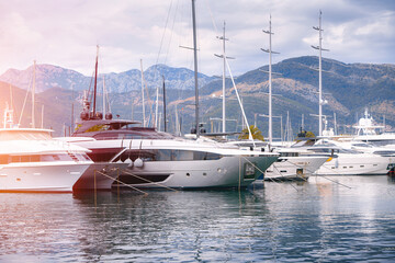 Yachts parked at marina with mountain backdrop