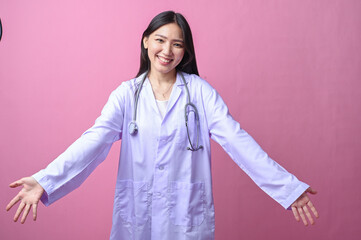 Asian female doctor in a white coat smiling with open arms, expressing a welcoming gesture while...