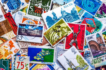 Postage stamps.A collection of world stamps in a pile.Postage stamps from different countries and...