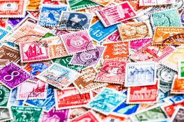 Postage stamps.A collection of world stamps in a pile.Postage stamps from different countries and...