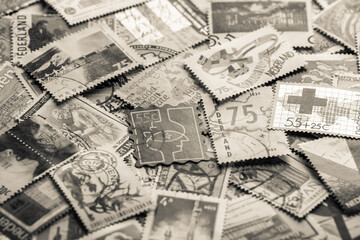 Postage stamps.A collection of world stamps in a pile.Postage stamps from different countries and...