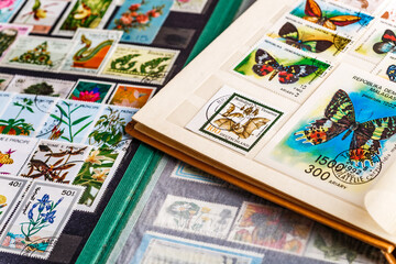 Postage stamps. Collection of stamps and magnifying glass. Collection of world stamps in a stack...