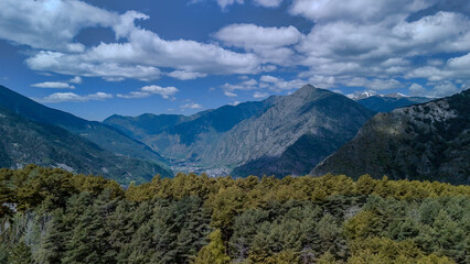 A beautiful mountain range with trees in the foreground