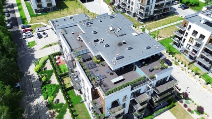 Aerial view of contemporary apartment complex with gardens