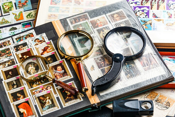 Postage stamps. Collection of stamps and magnifying glass. Collection of world stamps in a stack...