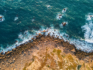 Aerial View of Ocean Waves Hitting Rocky Shore. Aerial drone view. natural background