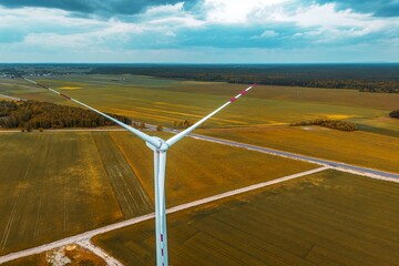 Green summer landscape with wind generator