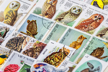 Postage stamps. Collection of stamps and magnifying glass. Collection of world stamps in a stack...