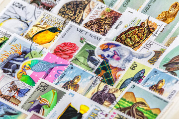 Postage stamps. Collection of stamps and magnifying glass. Collection of world stamps in a stack...