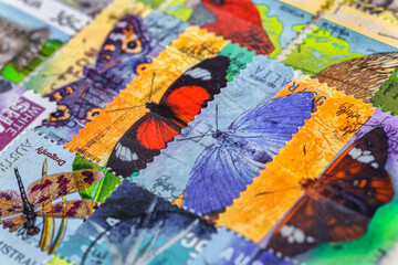 Postage stamps. Collection of stamps and magnifying glass. Collection of world stamps in a stack...