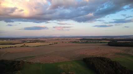 Aerial view of the landscape with fields and meadows at sunset