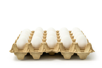 White chicken eggs in the cardboard egg tray with rooms for twenty eggs isolated on white...