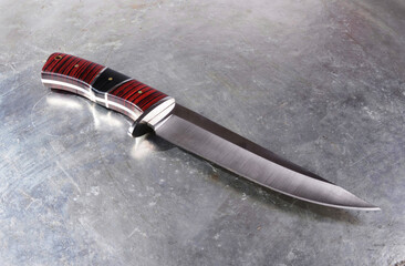 Hunting knife , with a wide single-edged sharpened blade, on an isolated background.