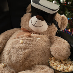 Home cinema concept with a teddy bear wearing VR glasses