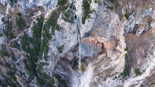 dynamic drone view of cascading high waterfall Rinka in the Kamnik-Savinja Alps of Slovenia