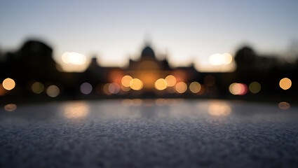 Blurred building lights reflecting on water at dusk bokeh reflection