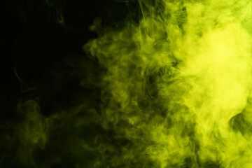 Hookah smoke in yellow light on black background, closeup