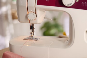 Closeup view of sewing machine with thread