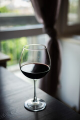 A glass of red wine in a cozy environment