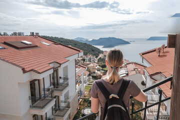 Woman enjoys solo travel, retreat and mindfulness sea, mountain, coast, marina; exploring slow adventure, freedom, calm, awareness, soft experience, relaxation, selfcare, youth lifestyle.