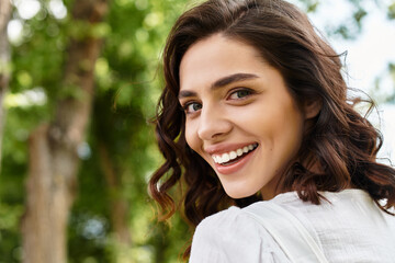 Joyful summer moments with a young woman in a vibrant outdoor park setting