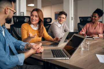 Colleagues Engaged in a Collaborative Team Meeting in a Modern Office Setting